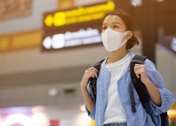 Asian travelers girl with medical face mask to protection the coronavirus in airport