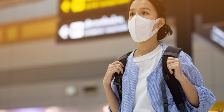 Asian travelers girl with medical face mask to protection the coronavirus in airport