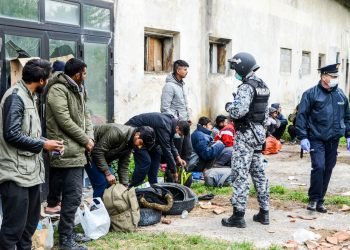 Transfering migrants to tent camp. Police action. Balkan route