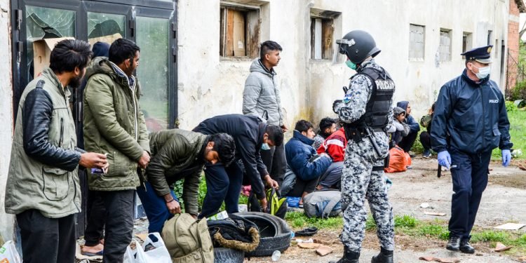 Transfering migrants to tent camp. Police action. Balkan route