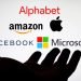 Big Five companies. Big Tech company logos: Alphabet, Amazon, Apple, Facebook, Microsoft on a screen and a silhouette of hand. Not a montage. Digital tax, antitrust.