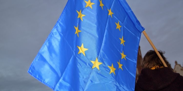 Flag of European Union hold by protester during pro-EU demonstration in Krakow after Polish government decided veto for european budget