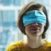 Woman in medical mask on eyes. Panic, fear, lying or disinformation during coronavirus pandemic concept.