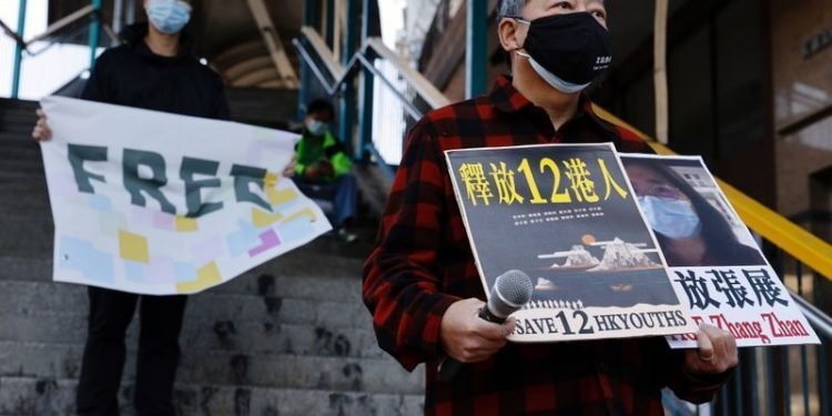 Pro-democracy supporters protest to urge for the release of 12 Hong Kong activists arrested as they reportedly sailed to Taiwan for political asylum and citizen journalist Zhang Zhan outside China's Liaison Office, in Hong Kong, China December 28, 2020