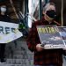 Pro-democracy supporters protest to urge for the release of 12 Hong Kong activists arrested as they reportedly sailed to Taiwan for political asylum and citizen journalist Zhang Zhan outside China's Liaison Office, in Hong Kong, China December 28, 2020