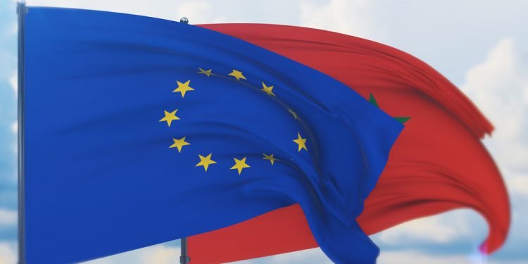 Waving European Union flag and flag of Morocco.