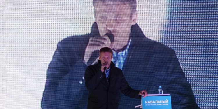 Russian politician Alexei Navalny against the background of a large screen