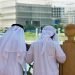 Two anonymous Arab men in traditional white clothing