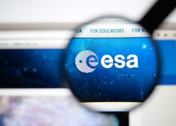 LISBON, PORTUGAL - June 6, 2015. Photo of European Space Agency homepage on a monitor screen through a magnifying glass.