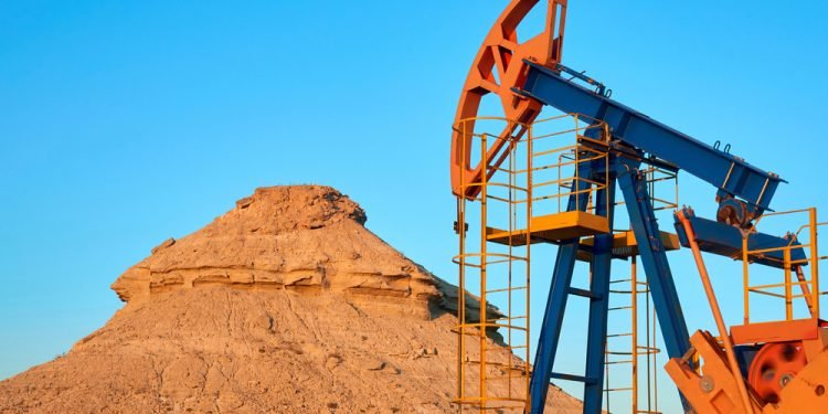 Oil pump are working in the blue sky background. World Oil Industry. Mangistau region. Kazakhstan