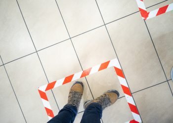 Tape on the floor of a McDonald's restaurant, so that customers practice social distancing, during the Coronavirus (covid-19) crisis.