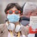 Warsaw, Poland 04.15.2020 - Protest of Entrepreneurs, woman with face mask holding Constitution of Poland