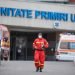 Bucharest, Romania - April 1, 2020: Romanian medical personnel wearing protective suits in the yard of a hospital closed for Covid-19 infection.