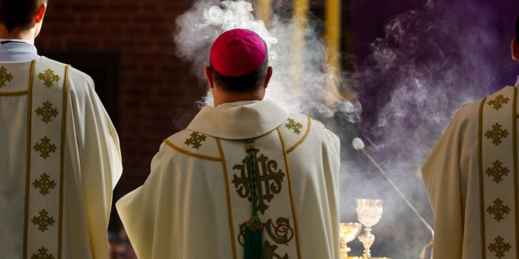 Bishop censes incense during Chrism Mass in the Cathedral Church of St. John the Baptist and St. John the Evangelist