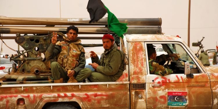 Libyan rebels travel to a battle line where they will fight Colonel Muammar Gaddafi's army. Ajdabiya, Libya, April 7, 2011