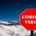 Coronavirus Covid-19 stop sign with ski resort in background.