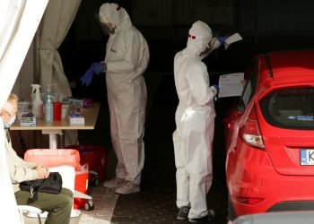 Krakow, Poland - October 10, 2020 : Red zone in Poland. A Giant car queue to perform tests - swabs for the presence of SARS-CoV-2 coronavirus at the collection point of the Diagnostyka Group