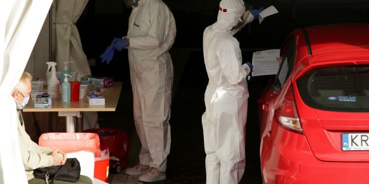 Krakow, Poland - October 10, 2020 : Red zone in Poland. A Giant car queue to perform tests - swabs for the presence of SARS-CoV-2 coronavirus at the collection point of the Diagnostyka Group