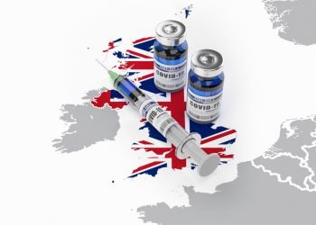 A syringe and two bottles of COVID-19 vaccine on UK map. Covid vaccination in Great Britain. 3d illustration