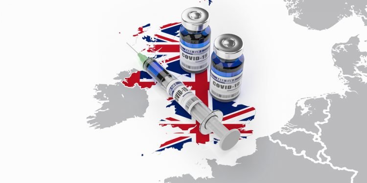 A syringe and two bottles of COVID-19 vaccine on UK map. Covid vaccination in Great Britain. 3d illustration