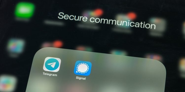 Close up of smartphone screen with focus on Telegram and Signal apps. These are encrypted and secure from end to end