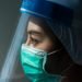 Closeup Asian female Doctor wearing face shield and PPE suit for Coronavirus outbreak or Covid-19