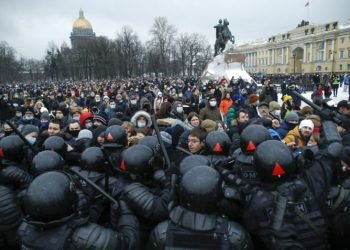 People clash with police during a protest against the jailing of opposition leader Alexei Navalny in St.Petersburg, Russia, Saturday, Jan. 23, 2021.