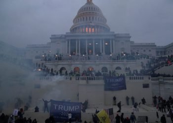 olice officers stand guard as supporters of U.S. President Donald Trump gather in front of the U.S. Capitol Building in Washington on January 6, 2021.