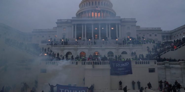 olice officers stand guard as supporters of U.S. President Donald Trump gather in front of the U.S. Capitol Building in Washington on January 6, 2021.