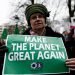 People hold placards and shout slogans during a protest against Trump's environmental policy at conference attended by Trump climate advisor Myron Ebell in Brussels, Belgium on Feb. 2017