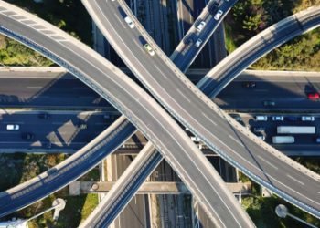 Aerial drone bird's eye view photo of latest technology cross shape multi level road highway passing through city center