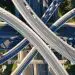 Aerial drone bird's eye view photo of latest technology cross shape multi level road highway passing through city center