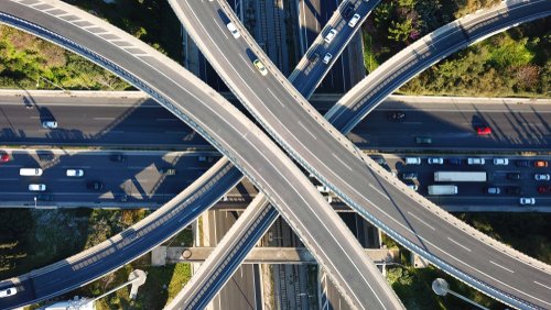 Aerial drone bird's eye view photo of latest technology cross shape multi level road highway passing through city center
