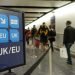 London, UK - April 15, 2018: Air travelers proceed along the UK/EU arrivals lane to passport control at Heathrow airport.