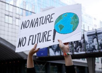 Brussels, Belgium. 8th Sep. 2018.Activists hold placards and chant slogans during a demonstration to demand immediate an action on climate change in front of European Parliament.