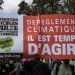 Paris, France – September 2014 – Demonstrators waving signs covered in slogan during the Climate March, event organized in France and countries around the world to protest against the climate change