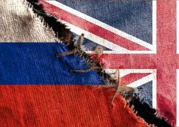 The gap between the two flags, Russia and Great Britain, as a concept of political confrontation.