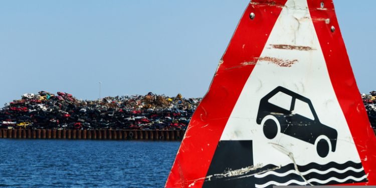 Scrap pieces and cars car wrecks at the port for export dumping, disposal illegal danger