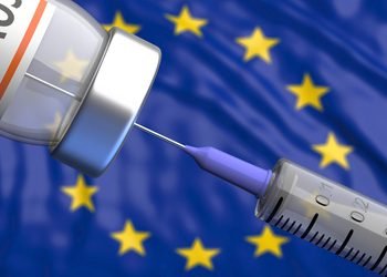 EU Coronavirus vaccine, Europe. Covid-19 vaccination, flu prevention, immunization concept. Vial dose and medical syringe, European Union flag background.