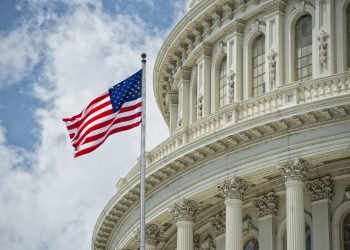 Washington DC Capitol dome detail with waving american flag