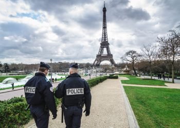 Paris, France - March 18, 2012: Patrols of two police officers in the Trocadero gardens and Eiffel Tower.