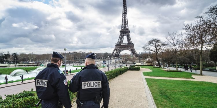 Paris, France - March 18, 2012: Patrols of two police officers in the Trocadero gardens and Eiffel Tower.