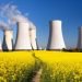 Panoramic view of Nuclear power plant Jaslovske Bohunice with golden flowering field of rapeseed, canola or colza - Slovakia - two possibility for production of electric energy