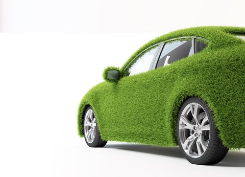 Green, ecofriendly transport concept - grass covered car.