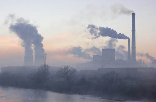 Smoking industrial chimneys at dawn. Concept for environmental protection