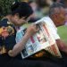 YANGON, MYANMAR - JANUARY 4, 2016: Unidentified woman reading newspaper in the park in Yangon, Myanmar on January 4, 2016