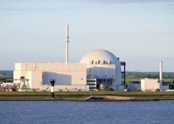 BROKDORF, GERMANY - June 4, 2017: Riverside view of Brokdorf Nuclear Power Plant. It started in October 1986 and the decommissioning is planned for 2021.