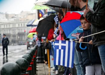 A boy holding a Greek flag during a military parade marking Greece's Independence Day in Athens, Greece on Mar. 25, 2015