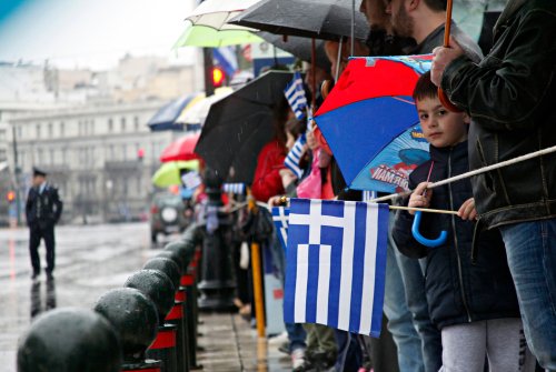 A boy holding a Greek flag during a military parade marking Greece's Independence Day in Athens, Greece on Mar. 25, 2015