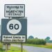 Editorial use only; a signpost and speed limit sign, the sign has the text ' Welcome to Northern Ireland ', taken outside Ballyconnell, Co. Cavan, Ireland, in July 2017.